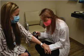  ?? PHOTO COURTESY OF MERCY HEALTH ?? Dr. Valerie Nemeth of Mercy Health Vermilion Primary Care treats a patient. Nemeth shared some helpful guidance on how to prevent and treat maskne, the skin irritation effects of wearing face masks.