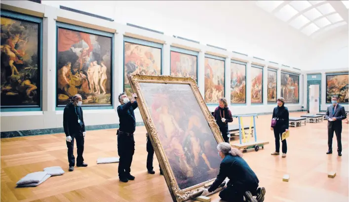  ?? DMITRY KOSTYUKOV/THE NEW YORK TIMES PHOTOS ?? Anthony van Dyck’s “Venus Asks Vulcan to Cast Arms for Her Son Aeneas” is moved by workers in January at the Louvre in Paris.