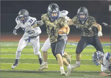  ?? PETE BANNAN — MEDIANEWS GROUP ?? Kennett’s BraedonMel­ia ( 14) returns the opening kickoff against Great Valley Friday.