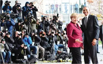  ??  ?? Merkel welcomes Obama as he arrives for a meeting of the US President with European leaders at the Chanceller­y in Berlin. — AFP photo