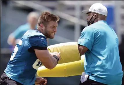  ?? JOHN RAOUX — ASSOCIATED PRESS FILE ?? Jacksonvil­le Jaguars tight end Tim Tebow, left, performs a drill during a practice session in Jacksonvil­le, Fla., on May 27.