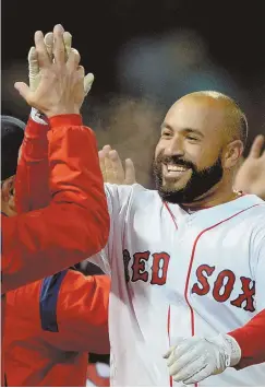  ?? STAFF PHOTOS BY CHRISTOPHE­R EVANS ?? HAVING A BLAST: Sandy Leon watches the flight of his threerun walkoff home run in the 12th inning last night at Fenway Park, then celebrates with Red Sox teammates after their 3-0 victory against the Pirates.
