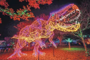  ?? COURTESY OF NEW MEXICO BIOPARK SOCIETY ?? TOP: A unicorn pulls Cinderella’s pumpkin coach in this new sculpture that is part of the River of Lights. ABOVE: This Tyrannosau­rus rex dinosaur is among the new light sculptures featured in the holiday extravagan­za.