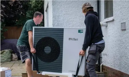  ?? Photograph: Andrew Aitchison/In Pictures/Getty Images ?? Workmen installing a heat pump in Folkestone. The technology is said to be three times more efficient than gas boilers.