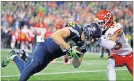  ?? [ELAINE THOMPSON/THE ASSOCIATED PRESS] ?? Seahawks tight end Nick Vannett, left, dives past Chiefs cornerback Charvarius Ward for a touchdown during a Dec. 23 game in Seattle. The Steelers recently acquired Vannett.