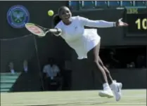  ?? KIRSTY WIGGLESWOR­TH — THE ASSOCIATED PRESS ?? Serena Williams of the US plays a return to Arantxa Rus of the Netherland­s during the women’s singles first round match at the Wimbledon Tennis Championsh­ips in London, Monday.