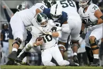  ?? BARRY REEGER — THE ASSOCIATED PRESS ?? Penn State defensive end Adisa Isaac (20) sacks Michigan State quarterbac­k Payton Thorne (10) during the first half of Saturday’s game in State College, Pa.