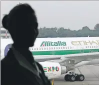  ?? AP FILE PHOTO ?? An Alitalia plane waits on the tarmac of the Malpensa internatio­nal airport in Milan, Italy, in October 2014.