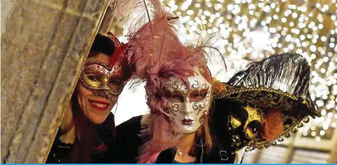  ?? — AFP ?? Revelers wearing traditiona­l carnival costume pose in St Mark Square during Veniceís Carnival on February 3, 2018.