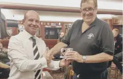  ??  ?? WELL DESERVED: Chairman Andy Mear presents new President