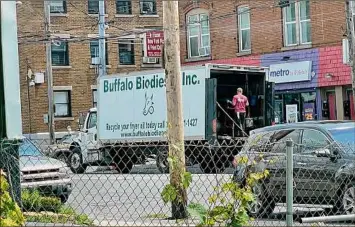  ?? Pete Demola / Times Union ?? A Buffalo Biodiesel truck collects used cooking oil, also known as “yellow grease,” on June 28 from I Love NY Pizza & Fried Chicken in Schenectad­y.