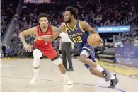  ?? — AFP photo ?? Andrew Wiggins #22 of the Golden State Warriors is guarded by Kenyon Martin Jr. #6 of the Houston Rockets at Chase Center in San Francisco, California.