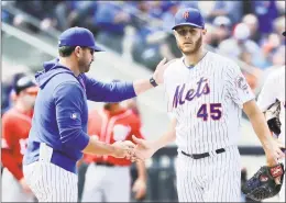  ?? Frank Franklin II / Associated Press ?? Mets manager Mickey Callaway, left, takes the ball from starting pitcher Zack Wheeler during the fifth inning on Sunday.