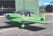  ??  ?? Ian Sinnott and a friend in his distinctiv­e green plane.