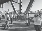  ?? KENTUCKY TRANSPORTA­TION CABINET ?? Kentucky and Ohio transporta­tion officials inspect the scorched bridge Thursday after debris from colliding semi-trucks was removed.