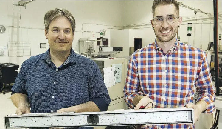  ?? IAN KUCERAK ?? G2V’s Michael Taschuk, left, and Ryan Tucker hold the company’s six-spectrum light bar, which mimics the variable intensity of the sun.