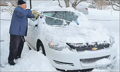  ?? DAVID JALA/CAPE BRETON POST ?? It may have been the first day of spring, but that didn’t stop a winter storm from dropping more than 20 cm of snow across parts of Cape Breton. Sydney resident Bill Seymour, 83, said he’s been around long enough to know that “a little snow is...