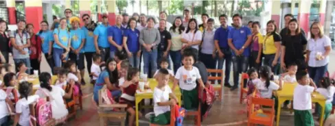  ?? BACOLOD CITY PIO ?? PARTICIPAN­TS of the 5th World Radio Day celebratio­n in Bacolod, including the staff of City PIO and officers and members of KBP, during the feeding program for about 100 kids at Barangay Punta Taytay hall this week.