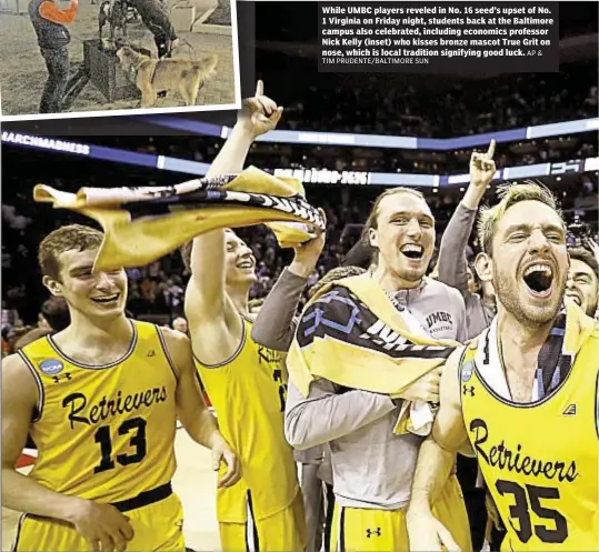  ?? TIM PRUDENTE/BALTIMORE SUN AP& ?? While UMBC players reveled in No. 16 seed’s upset of No. 1 Virginia on Friday night, students back at the Baltimore campus also celebrated, including economics professor Nick Kelly (inset) who kisses bronze mascot True Grit on nose, which is local...