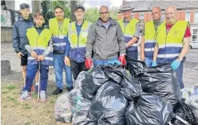  ??  ?? Pride in Pill members with some of the rubbish they collected on one of their litter picks