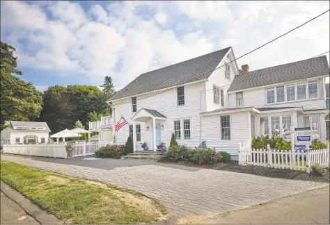  ?? Dennis M. Carbo / Contribute­d photo ?? This Madison home, just three doors from the Madison Beach Club, has an incredible number of windows that provide an abundance of light and views of Tuxis Island.