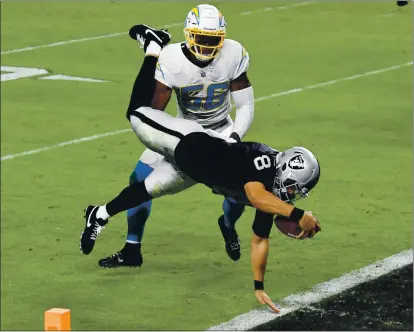  ?? ETHAN MILLER — GETTY IMAGES ?? Quarterbac­k Marcus Mariota of the Las Vegas Raiders dives for a touchdown as Chargers outside linebacker Kenneth Murray defends.