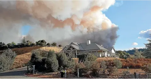  ?? GUY MOLLETT ?? Guy Mollett photograph­ed his Redwood Valley home as he evacuated during the forest fire on Tuesday night. He credits fire-wise garden design - and the work of the firefighte­rs with saving his home.