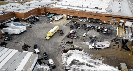  ?? BEV HORNE / DAILY HERALD (AURORA, ILLINOIS) ?? By Michael Brice-Saddler, Emily Wax-Thibodeaux, Reis Thebault Law enforcers gather at the scene of Friday’s shooting at an industrial park in Aurora, Illinois. At least five are dead and five wounded, officials said. The suspect, identified as Gary Martin, 45, was killed in an exchange of gunfire with police, officials said.