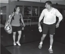  ?? — B. SATISH ?? Saina Nehwal with new coach U. Vimal Kumar at the Tata Padukone Badminton Academy in Bengaluru on Tuesday.