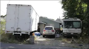  ?? TED S. WARREN ?? Vehicles are parked outside the home of Paige A. Thompson, who uses the online handle “erratic,” Wednesday, July 31, 2019, in Seattle. Thompson was taken into custody Monday at her home and has been charged with computer fraud and abuse in connection with hacking data from more than 100 million Capital One credit holders or applicants.