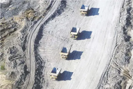  ?? BEN NELMS/BLOOMBERG FILES ?? Global oil majors are under pressure to reduce their carbon footprints, providing a push to sell their holdings in Canada's oilsands, which have a higher CO2 intensity than convention­al oil. Above, bitumen mining at Suncor Energy Inc. in Fort McMurray.