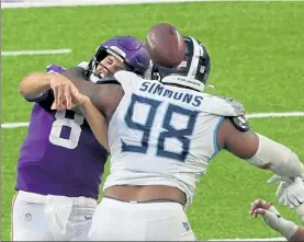  ?? ADAM BETTCHER / GETTY IMAGES ?? Minnesota’s Kirk Cousins gets hit by Jeffery Simmons of the Tennessee Titans in the fourth quarter on Sunday in the Vikings’ 31-30 loss on Sunday.