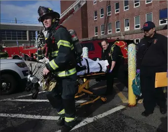  ?? NANCY LANE — BOSTON HERALD ?? Patients are evacuated from Brockton Hospital after a transforme­r fire caused a multiple alarm fire on Tuesday.