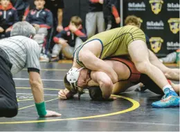  ?? JANE THERESE/SPECIAL TO THE MORNING CALL ?? Keegan Ramsay, top, of Notre Dame-Green Pond, wrestling Jared Rohn, of Saucon Valley, in the District 11 2A finals on Feb. 3, is a medal contender at 172.