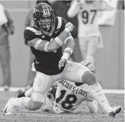  ?? MATT GENTRY/THE ROANOKE TIMES VIA THE AP ?? Virginia Tech defender Dax Hollifield (4) says “The sideline that brings the most juice is definitely going to have the edge, and I’m excited for it. I hope we can do it.”