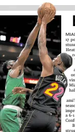  ?? —USA TODAY SPORTS ?? Boston Celtics guard Jaylen Brown (left) blocks the shot of Miami Heat forward Jimmy Butler.