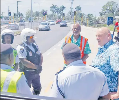  ?? Picture: ATU RASEA ?? Fiji Roads Authority chief executive officer Jonathan Moore (right) in discussion with police officers during the opening of the new Nakasi-Koronivia four-lane road along the Suva-Nausori corridor.