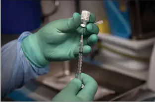  ?? JAE C. HONG — THE ASSOCIATED PRESS ?? The Pfizer COVID-19vaccine at a mobile vaccine clinic Aug. 26in Santa Ana, Calif. An internatio­nal group of scientists is arguing the average person doesn’t need a COVID-19 booster yet.