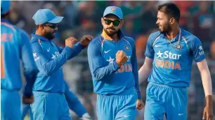  ?? AP ?? India’s Ravindra Jadeja (left), captain Virat Kohli (centre) and Hardik Pandya celebrate the dismissal of England’s Jos Buttler during the third one-day internatio­nal in Kolkata. —