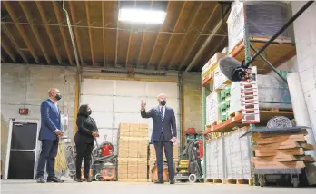  ?? CAROLYN KASTER/AP ?? President Joe Biden visits Smith Flooring Inc. in Chester Township, Delaware County, where he was joined Tuesday by owners Kristin and James Smith.