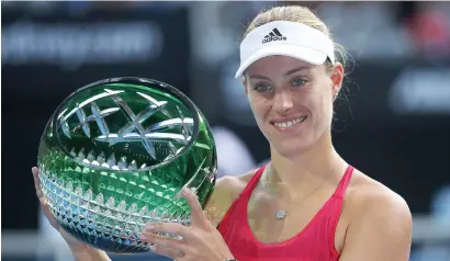  ?? AP ?? Angelique Kerber holds her trophy after her win over Ash Barty in the final at the Sydney Internatio­nal tennis tournament in Sydney. —