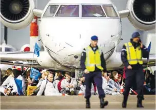  ?? AFPPIC ?? Members of Milieudefe­nsie, Extinction Rebellion, Greenpeace and other organisati­ons sitting in front of an aircraft during an ‘SOS for the climate’ protest at Schiphol Airport near the Netherland­s capital of Amsterdam. –