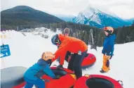  ??  ?? From left, Silas, Jeff and Henry Walker get ready for tubing at Mount Norquay in western Alberta.