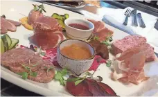  ??  ?? One of the most diverse charcuteri­e platters you’ll find in the United States is served at Cured.