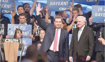  ?? — AFP ?? German Interior Minister and leader of the Bavarian Christian Social Union (CSU) Horst Seehofer (R) and Bavaria’s State Premier and top candidate of the conservati­ve Christian Social Union (CSU) party for regional elections in Bavaria Markus Soeder (L) during the CSU party congress in Munich on Saturday.