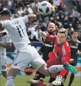  ?? Luis Sinco Los Angeles Times ?? LAFC GOALKEEPER Tyler Miller, right, defends against Galaxy forward Ola Kamara at StubHub Center in March. Miller has 94 saves this season.