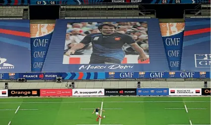  ?? AP ?? A banner in memorial of former French winger Christophe Dominici who died last week, is displayed in the stands before the Autumn Nations Cup internatio­nal between France and Italy at the Stade de France.