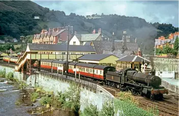  ?? COLOUR RAIL ?? Llangollen station – from where the line from Ruabon passed on its way to Barmouth Junction, Here, an unidentifi­ed ‘Manor’ 4-6-0 restarts an eastbound train on August 2, 1953.