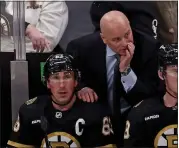  ?? STAFF PHOTO — STUART CAHILL/ BOSTON HERALD ?? Boston Bruins head coach Jim Montgomery and left wing Brad Marchand look on from the bench as the Bruins take on the Senators at the TD Garden on Tuesday.