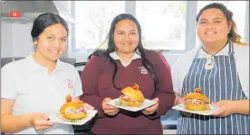  ??  ?? FROM left, Pomare Butler, Hinerangi Butler and Maddison Butler with their pulled pork roll.